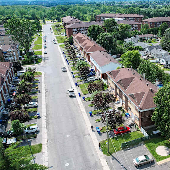 a street view of a residential area with houses on both sides.
