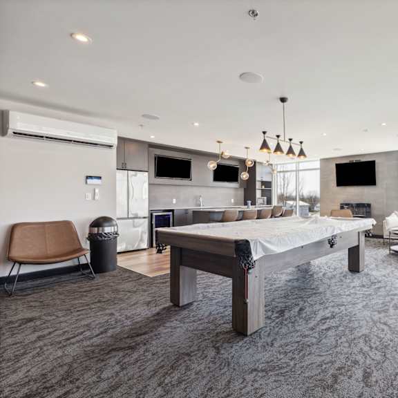 a modern living room with a long table and chairs.