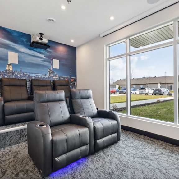 a home theater with a large screen and comfortable seating.