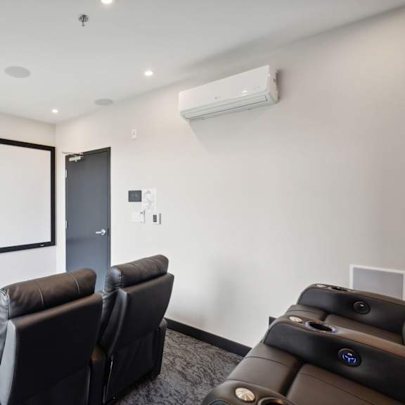 a home theater with a large screen and comfortable seating.