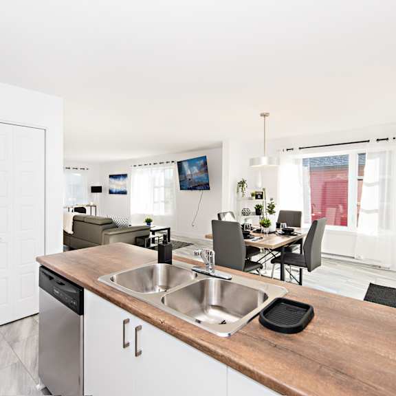 a kitchen with a wooden counter top and stainless steel appliances.