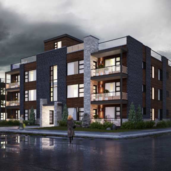 a woman is walking on a wet street in front of a large apartment building.