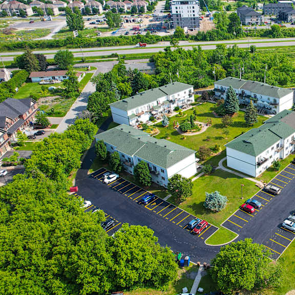 a bird's eye view of a residential area with houses and a parking lot.