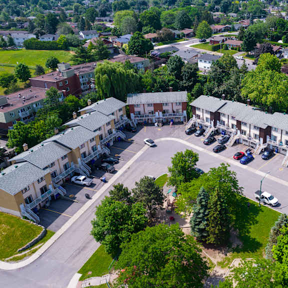 a bird's eye view of a residential area with houses and parked cars.