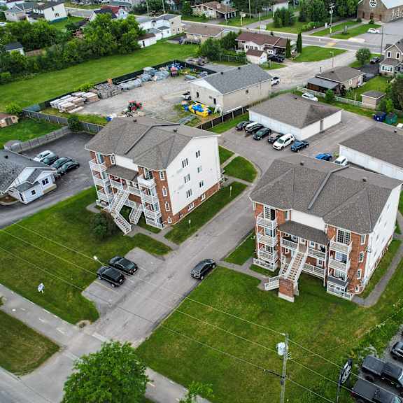 a bird's eye view of a residential area with houses and cars.