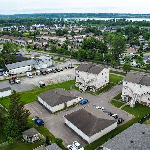 a bird's eye view of a residential area with houses and cars.