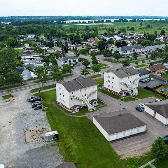 a bird's eye view of a residential area with houses and parked cars.