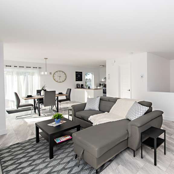 a modern living room with a grey sofa and a coffee table.