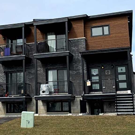 a large multi-story building with balconies and stairs.
