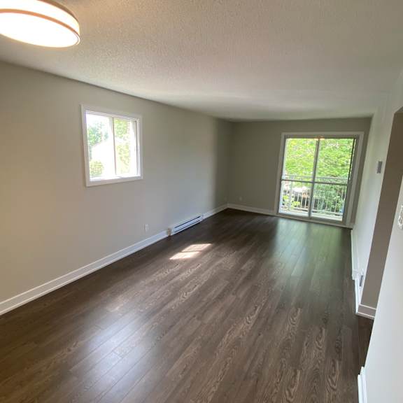 a room with wooden floors and a window.