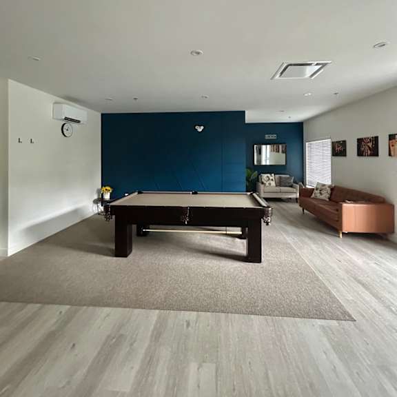 a pool table in a room with a blue wall.