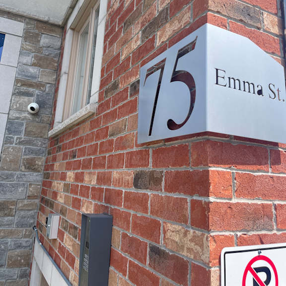 a brick wall with a sign that says emma st.