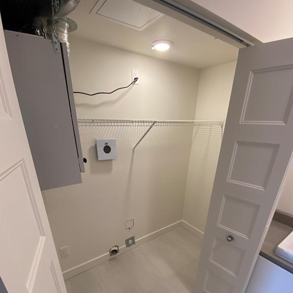 a white bathroom with a toilet and a shower.