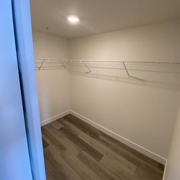 a room with a white wall and a grey floor.