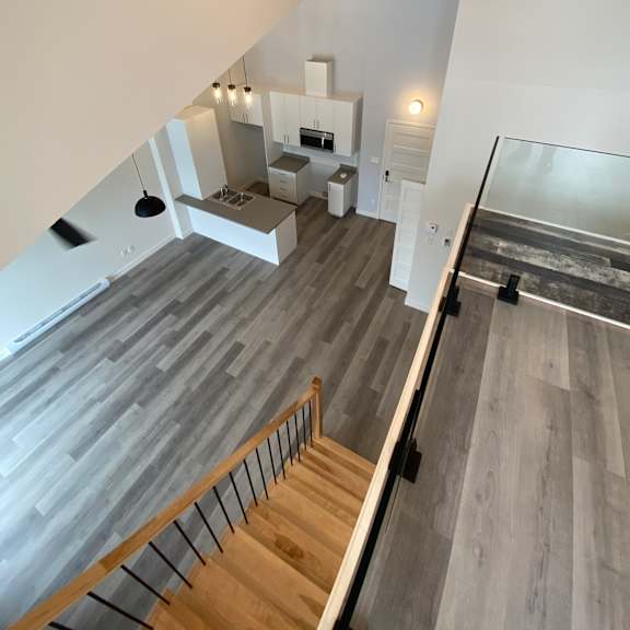 a modern house interior with a staircase leading to the second floor.