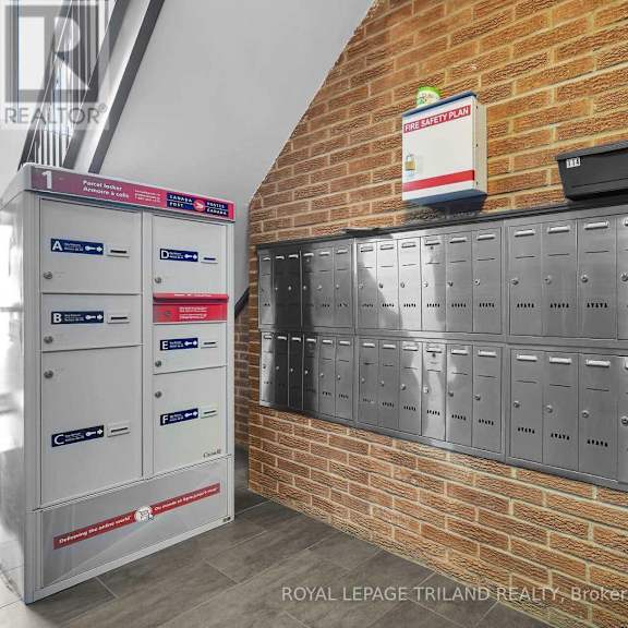 a row of mailboxes are lined up against a brick wall.