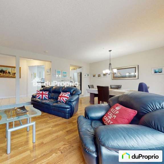 a living room with a blue couch and a glass coffee table.