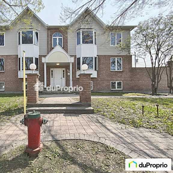 a brick building with a sign that says "our property" in front of it.