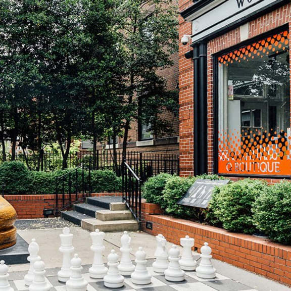 a large chess board in front of a building