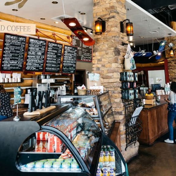 the interior of a coffee shop with a bar and a sign