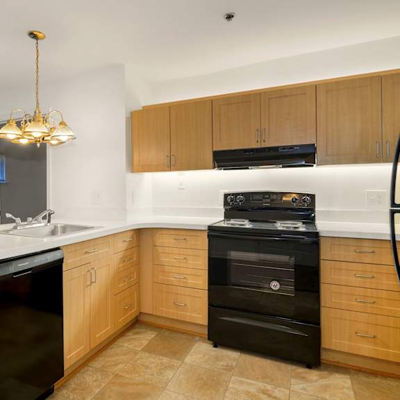 a kitchen with a black oven and a white counter.