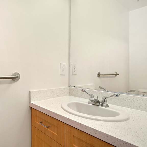 a bathroom with a sink and mirror.