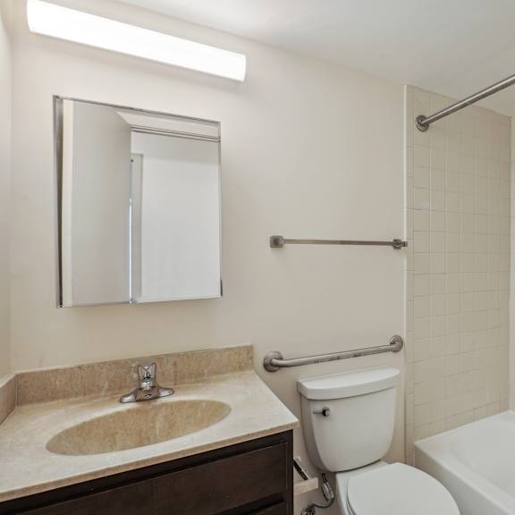 a white toilet sits next to a sink in a bathroom.