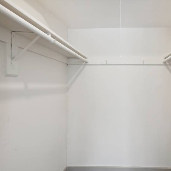 a white room with a grey floor and white walls.
