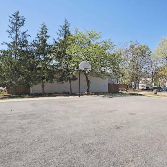 a basketball court with a hoop and a basketball on the ground.