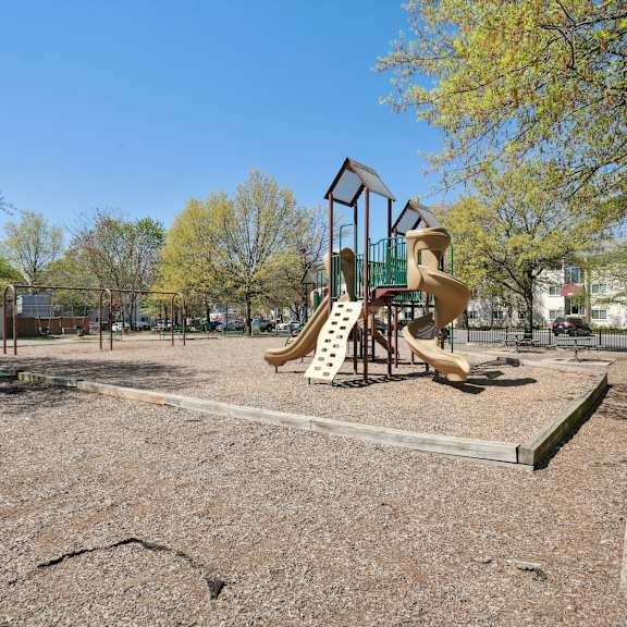 a playground with a slide and a swing set.