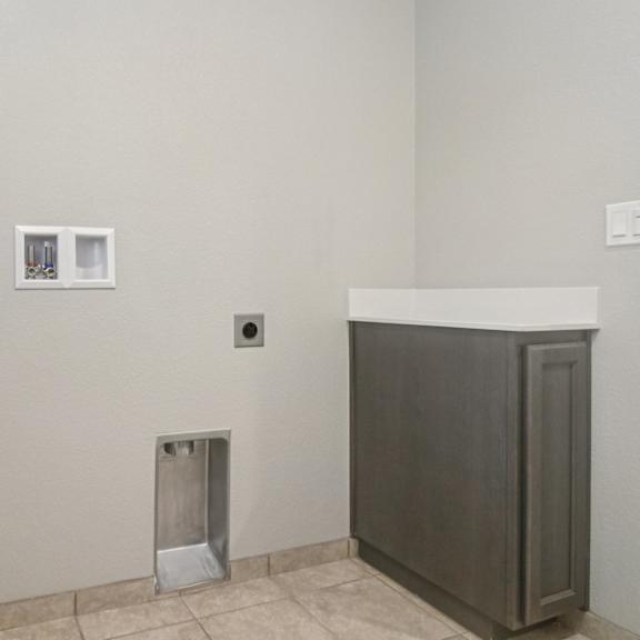 a bathroom with a toilet and a cabinet.