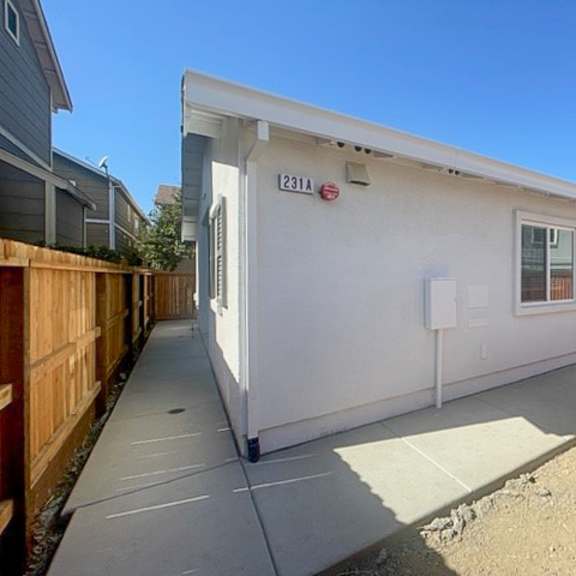 a small white building with the number 231a on it.
