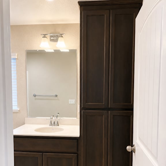 a bathroom with a sink, mirror, and medicine cabinet.