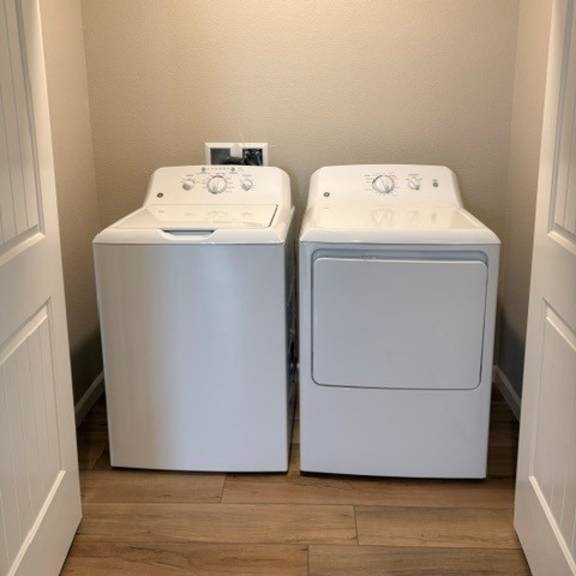 two white front loading washing machines in a small laundry room.
