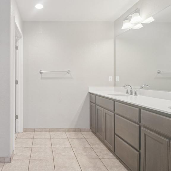 a bathroom with a white sink and a white door.