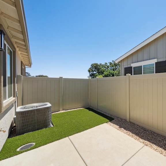 a tan fence surrounds a house at montessa apartments, california