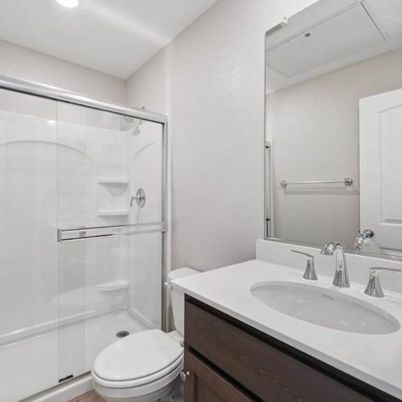 a white bathroom with a sink at montessa apartments, vacaville, ca