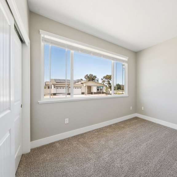 a room with a large window at montessa apartments, california