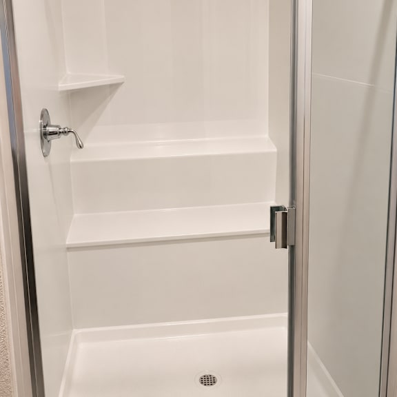 a bathroom with a toilet, sink, and window.