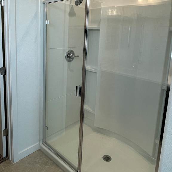 a white refrigerator with a glass door and a handle on the top.