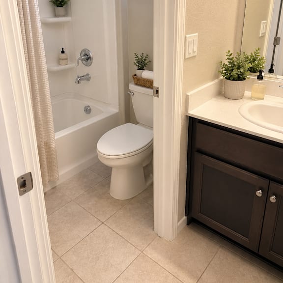 a white toilet in a bathroom with a white shower curtain.