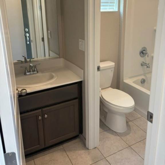 a white toilet is in a bathroom with a sink and mirror.