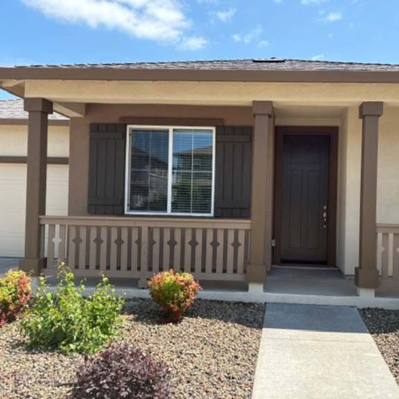 a house with a brown door and a brown porch.