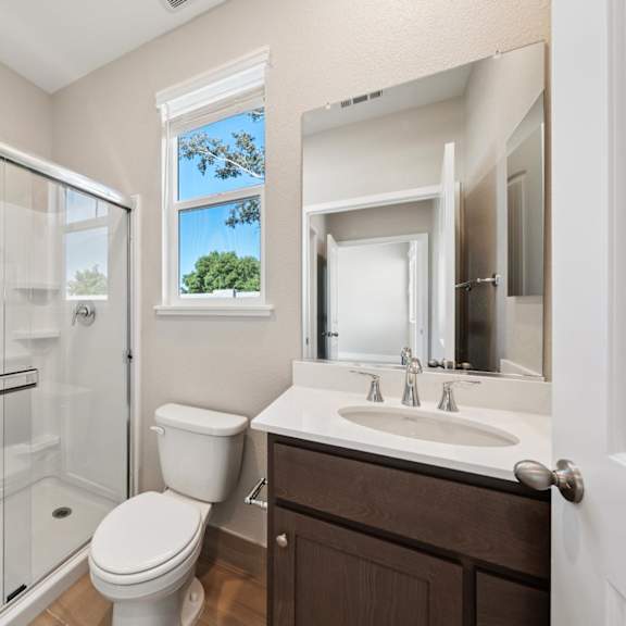 a bathroom with a mirror at montessa apartments, vacaville