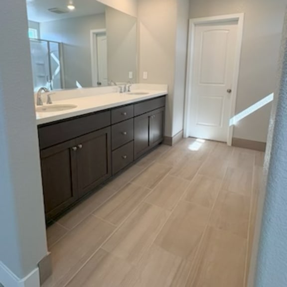 a bathroom with a vanity and a large mirror.