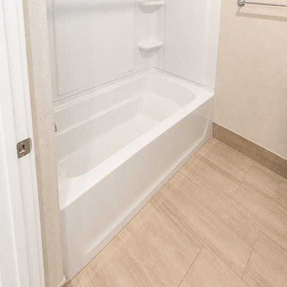 a white bathroom with a walk in shower.