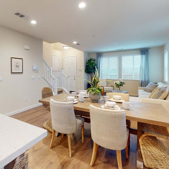 a dining room with a table set for six.
