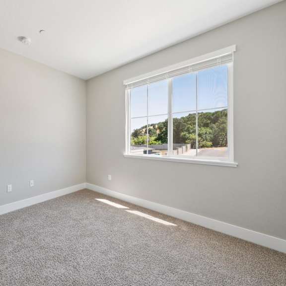 a room with a white walls at montessa apartments, vacaville, california