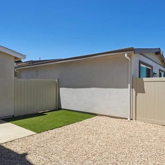 backyard with gravel driveway at montessa apartments, california, 95687