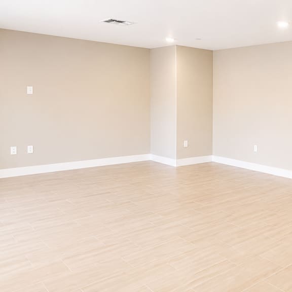 empty room with wooden floor and white walls.